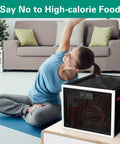 Woman doing yoga near Lockable Medication Storage Box With Code For Medicine And Personal Items Ideal For Dorm Home Or Office Keeps Meds And Phone Safe From Kids Fridge Black, placed on table, box with snacks inside.