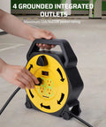 Person using Retractable 25 Feet Extension Cord Reel With 4 Grounded Outlets And 13 Amp Breaker, 16/3 SJTW Cord