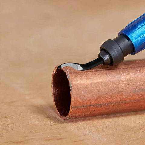Close-up of Beefed Up Deburring Blades Set 45 Degree Burr Remover Hand Tool For Holes Up To 1.5mm in action on copper pipe