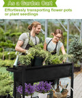 Raised Garden Bed On Legs With Wheels For Outdoor Plants An Elevated Planter Box Cart With Durable Powder Coated Metal Frame And Waterproof Fabric Grow Bag Yard Ready Weather Resistant For Vegetables Flowers And Herbs Patio Black in use with people gardening on a patio.
