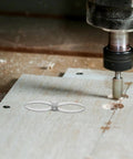 Badass Stainless Steel Double Ended Woodturning Calipers for Precise Internal And External Measurements on wooden surface.