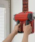 Person using 4580W Electric Wall Planing Machine Pure Copper Motor Tungsten Steel Blades on a wall to strip concrete.
