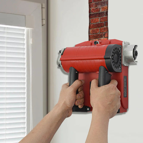 Person using 4580W Electric Wall Planing Machine Pure Copper Motor Tungsten Steel Blades on a wall to strip concrete.
