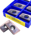 Grab These 10 Piece APMT160408 YBG205 Indexable Carbide Lathe Tools That Rock On Steel And Stainless For Serious Machining Action in a blue tray.