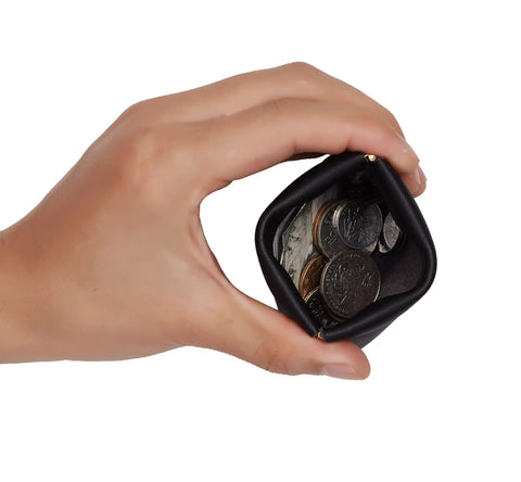 Smooth Vintage Black Leather Squeeze Coin Purse With Heavy Duty Spring Frame, compact change holder filled with coins.