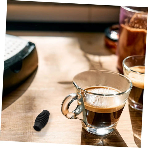 Heat Insulation Pad Rubber Sleeve For Espresso Steam Wand Burn Protection next to coffee cup on wooden table