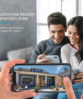 Couple using phone with Wireless Outdoor Security Camera With 2K Solar Power, Spotlight And Siren, AI Motion Detection app