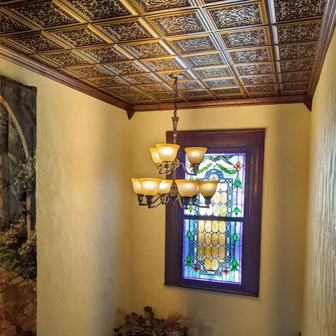Lover's Knot 2x2 PVC Glue-Up Ceiling Tile in Antique Copper Finish installed in hallway ceiling