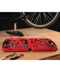 107 Piece Home And Auto Tool Set With Reversible 3/8 Inch Drive Ratchet, Pliers, Wrenches displayed in red case on a table