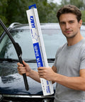 Man holding Premium 26 And 16 Inch Front Windshield Wiper Blades 2 Pack with package, showcasing easy install and rubber material.