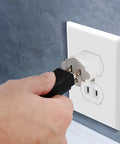 Hand plugging into a wall outlet using 2 Pack ETL Listed 3-Prong To 2-Prong Adapter, Fireproof PBT Material, 125V 15A Converter