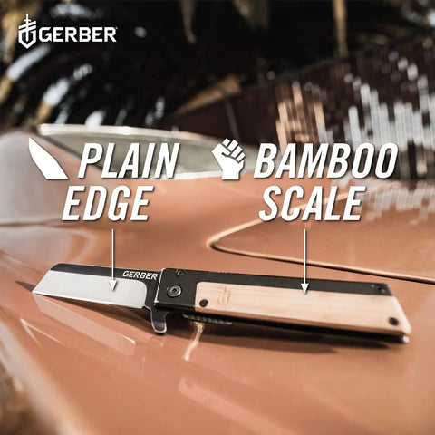 Quadrant Clip Folding Knife With Bamboo Handle, 2.7 Inch Stainless Plain Edge Blade on a car hood