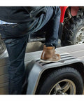 Person stepping on a trailer with Grippy Slip Resistant Tape Heavy Duty Black 4 Inch By 6 Foot Self Adhesive Anti Skid Tape visible.