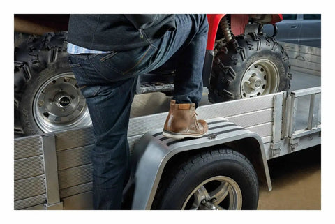 Person stepping on a trailer with Grippy Slip Resistant Tape Heavy Duty Black 4 Inch By 6 Foot Self Adhesive Anti Skid Tape visible.