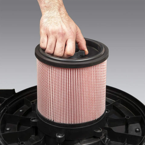 Hand installing Fine Dust Cartridge Filter And Retainer For Vacuum Cleaners Fits Most Five To Twenty Gallon Units.