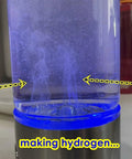 Image of a hydrogen water generator bottle creating hydrogen, visible through a clear container with blue lighting.