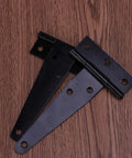 Two black T shape hinges from Dope 24 Pack Black T Shape Hinges 4 Inch Heavy Duty Iron Gate Hinges With 6 Pre Drilled Holes Multi Purpose Door Hardware