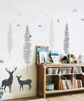 Dreamy Forest Woodland Nursery Wall Decals Set With Pine Trees Owls And Deer in playroom with books and toys