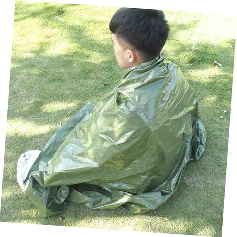 Person wrapped in olive green blanket from Three Piece Camping Survival Kit With Reflective Thermal Emergency Blanket And First Aid Gear
