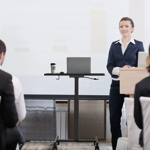 Business presentation featuring mobile standing desk on wheels with height adjustable range from 28.5 to 42.5 inches rolling workstation.