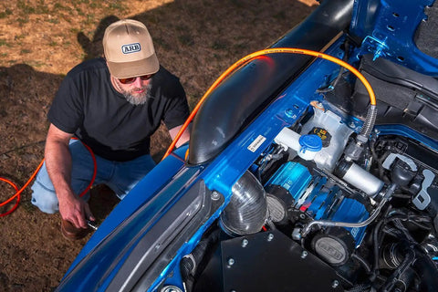 Premium Twin Motor 12V Brushless Air Compressor Built For Offroad Trucks shown installed with air hose for quick inflation.