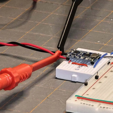 Two Pack Multimeter Test Lead Set With Wire Piercing Probes And Insulated Back Probes For Diagnostic Electrical Testing, Pro Grade 4mm Banana Plug Leads For Automotive Use, Heat And Cold Resistant, Non Slip Grip connected to a circuit board.