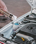 Hand holding Radiator Stop Leak Sealer And Conditioner Kit For Cooling System Repair near open car engine