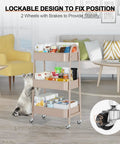 Three Tier Rolling Utility Cart With Lockable Wheels And Handy Metal Handle, Metal Storage Organizer On Wheels With Mesh Baskets For Kitchen, Living Room, Office Or Garage Beige Finish shown in a living room with a cat nearby.