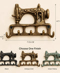 Slick Vintage Cast Iron Sewing Machine Wall Hook Rock Solid For Hanging Coats And Everyday Keys in antique gold finish, 7.3in W, 4.7in H.