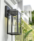 Durable Black Exterior Wall Lanterns With Hella Weatherproof Build For Backyards And Patios close-up of metal lantern with glass shade.