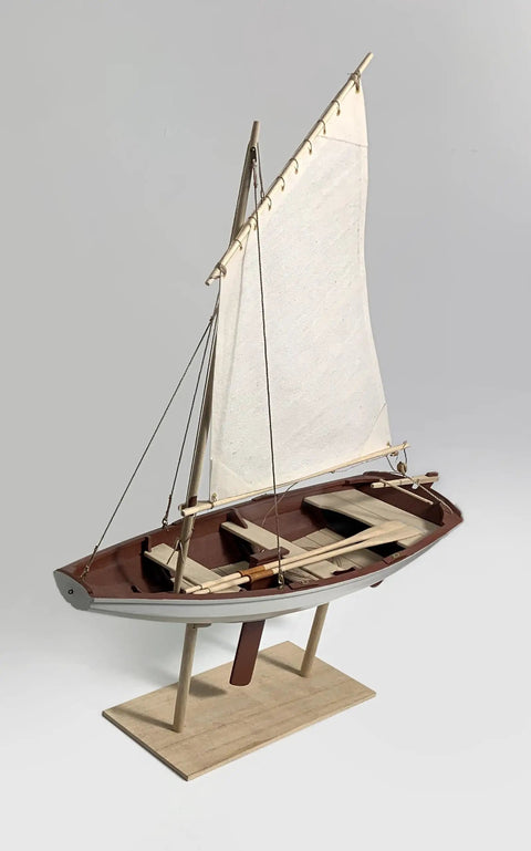 Norwegian Sailing Pram Model Kit 1:12 Scale For Adults, DIY Woodcraft Project, side view on stand, sail fully deployed.