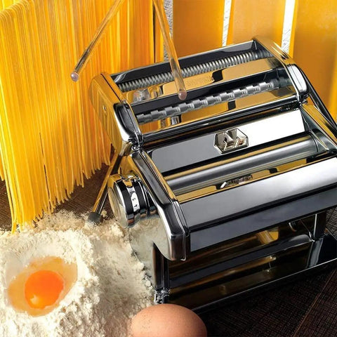 Manual Noodle Press And Dough Roller With Adjusted Thickness Dials delivering homemade pasta next to flour and egg.