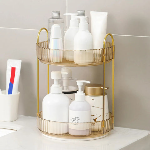 Kick Back And Organize Your Vanity Game With This Smooth Spin 360 Rotating Makeup Organizer Featuring Two Tier High Capacity Storage For Cosmetics Skincare And Perfume In Classic Amber Gold holding various skincare bottles.