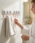 Heavy Duty Six Hook Adhesive Wall Rack With Smooth 180 Degree Swivel And Easy No Drill Mount ideal for stashing towels in a bathroom.