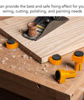 Heavy Duty Three Quarter Inch Aluminum Workbench Dogs Eight Pack With Grippy Pads on a wood surface during use with sawdust visible.