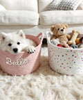 Must Have Personalized Dog Toy Storage Basket With Name Custom Pet Bin in pink and white, featuring a dog and toys on a rug.