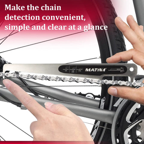 Hands using CC-4 Bike Chain Wear Gauge And Checker Tool For Quick And Accurate Chain Wear Readings on a bicycle chain.