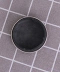 2pcs Rubber Bathtub Drain Stopper for Kitchen and Laundry Use, round black rubber plug with silver rim on a textured surface.