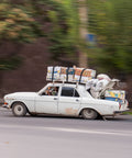 Car loaded with boxes and luggage on roof driving, suitable for Beefy Heavy Duty Cinch Tie Down Straps With Cam Buckles 4 Pack 1m