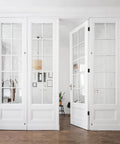 White folding doors with glass panels installed with 3 Pack Black Exterior Door Hinges 4 Inch With Five Eighth Inch Radius Removable Pin Rust Resistant And No Squeaks For Heavy Duty Front And Back Doors Includes Screws Durable Steel Construction For Long Lasting Exterior Use
