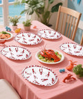 50 Pack Crawfish Boil Disposable Paper Plates Red Grid Oval Heavy Duty Design For Seafood Feasts Backyard Kickbacks Measuring 10X12 Inches on a table with food.