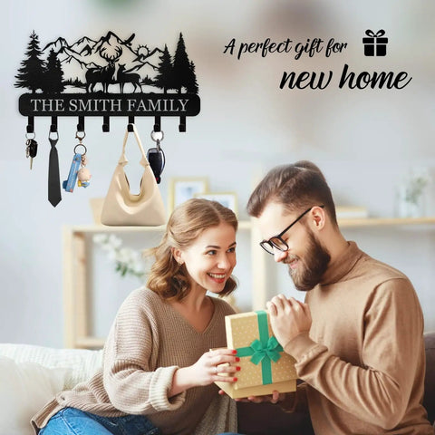 Custom Name Wall Key Holder With Forest Deer Design Dope Metal Coat Rack in living room scene, couple holding gift