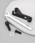 IS Mount To Flat Mount Brake Adapter with wrench and bolts on a soft surface