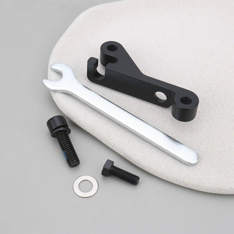 IS Mount To Flat Mount Brake Adapter with wrench and bolts on a soft surface
