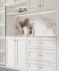White cabinet with Hot Brushed Gold Cabinet Knobs Set 50 Pack Stainless Steel Drawer Pull Handles in modern kitchen.