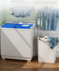 Dual Tub Portable Washing Machine With 30 Lb Wash Barrel And 18 Lb Spinner Drain Pump in a laundry room setting with clothes hang drying.