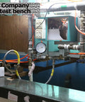 Industrial test bench with pipes, gauges, and electrical components for testing Ultra Compact 10W Hydroelectric Generator.