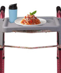 Walker Tray For Rollator And Standard Walkers, Folding Tray Table With Two Cup Holders, Tool Free Assembly, Fits Most Walkers About 18 Inches Wide, Easy Mount, Go-To Durable Plastic Mobility Accessory with plate and cup on tray.