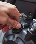 Close-up of a hand attaching a durable iron transmission gear reduction unit packing serious gasoline engine kick to an engine.