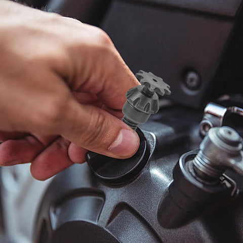 Close-up of a hand attaching a durable iron transmission gear reduction unit packing serious gasoline engine kick to an engine.